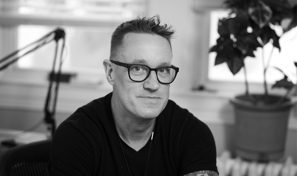 Bobby Gillespie, Creative Director, author of Build Your Brand Like You Give a Shit, headshot in black and white.